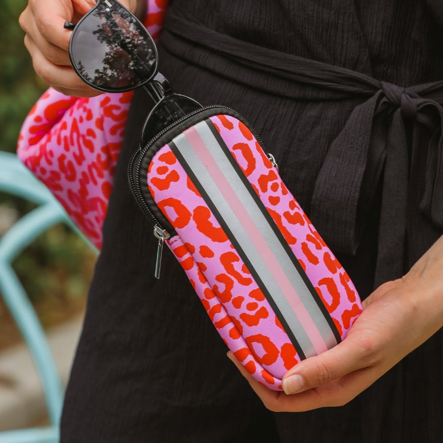 ultra-lightweight sunglasses case made of neoprene with a top double zipper in silver hardware and corresponding racing stripes in pink leopard