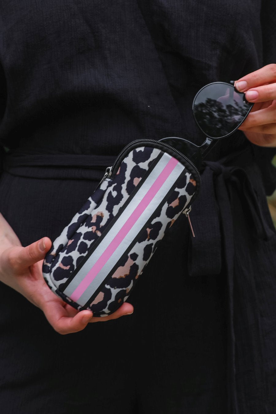 ultra-lightweight sunglasses case made of neoprene with a top double zipper in silver hardware and corresponding racing stripes in tan leopard