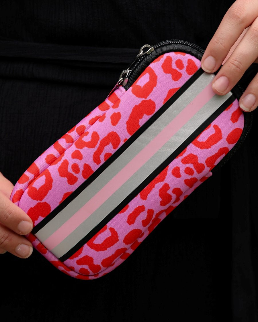 ultra-lightweight sunglasses case made of neoprene with a top double zipper in silver hardware and corresponding racing stripes in pink leopard