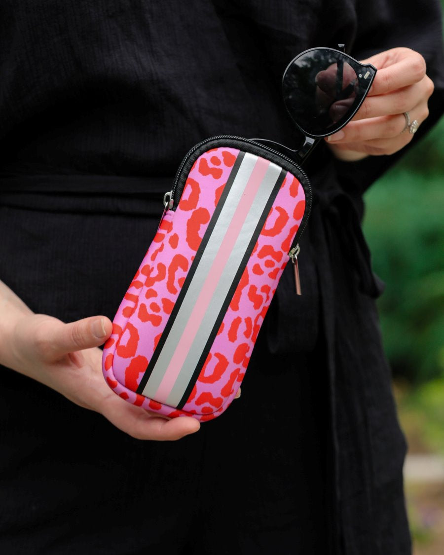 ultra-lightweight sunglasses case made of neoprene with a top double zipper in silver hardware and corresponding racing stripes in pink leopard