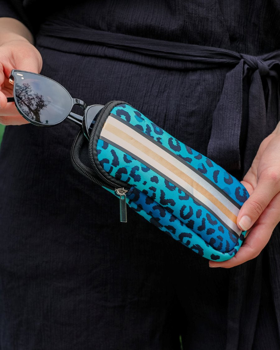 ultra-lightweight sunglasses case made of neoprene with a top double zipper in silver hardware and corresponding racing stripes in turquoise leopard