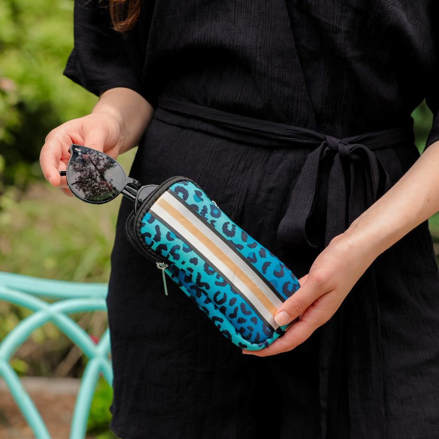 ultra-lightweight sunglasses case made of neoprene with a top double zipper in silver hardware and corresponding racing stripes in turquoise leopard
