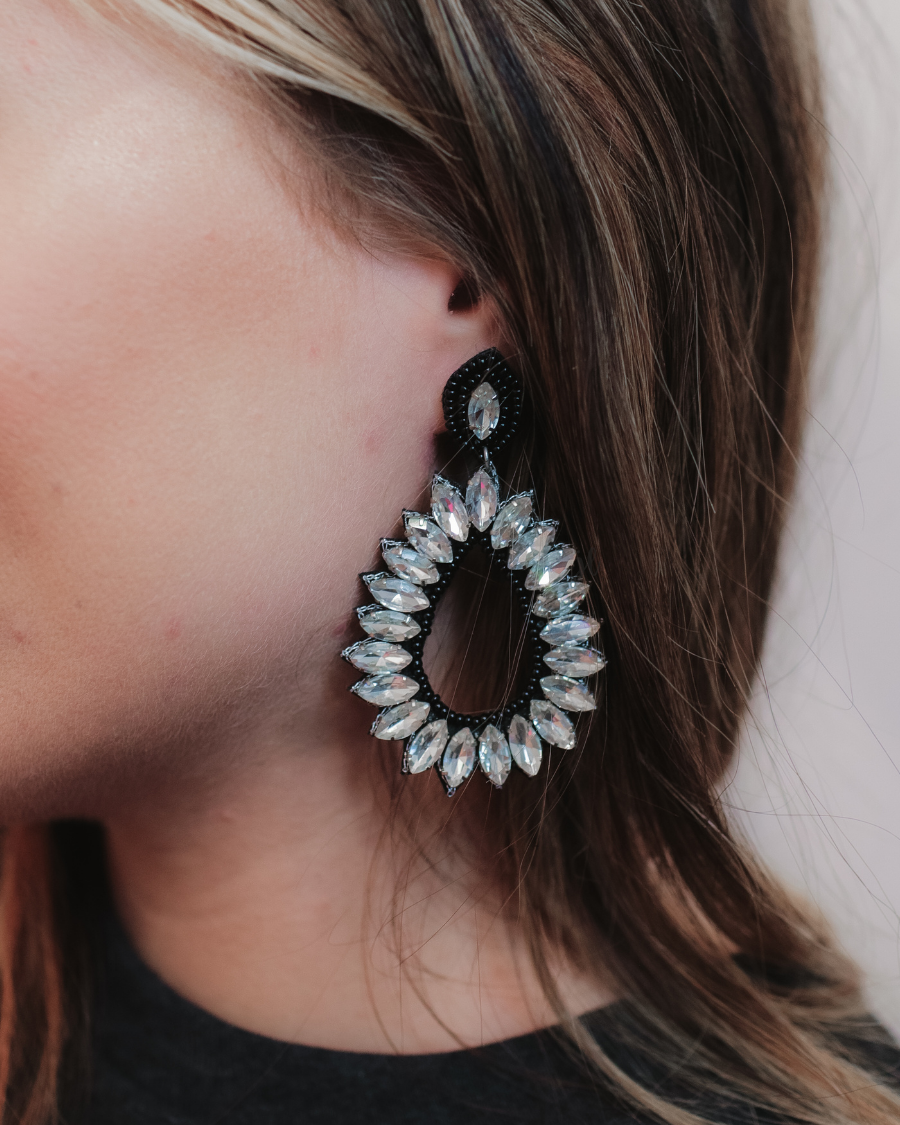 black rhinestone-embellished teardrop drop earrings with a subtle dangle movement, a coordinating stud top, soft felt backing, and secure comfort back