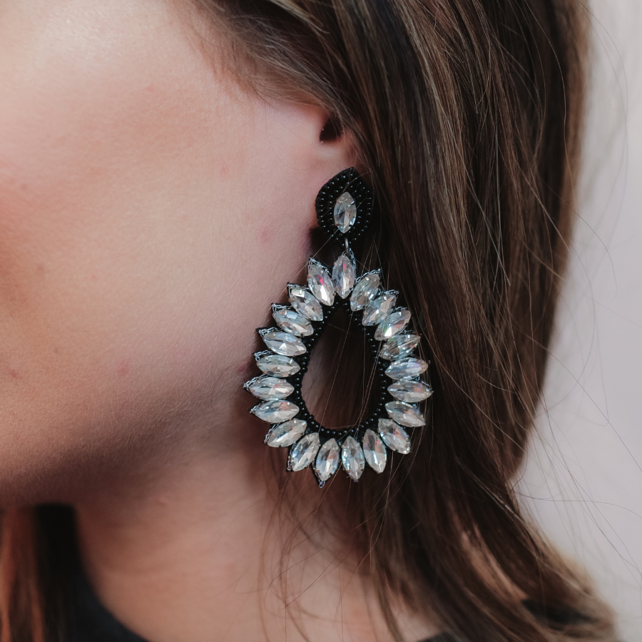 black rhinestone-embellished teardrop drop earrings with a subtle dangle movement, a coordinating stud top, soft felt backing, and secure comfort back