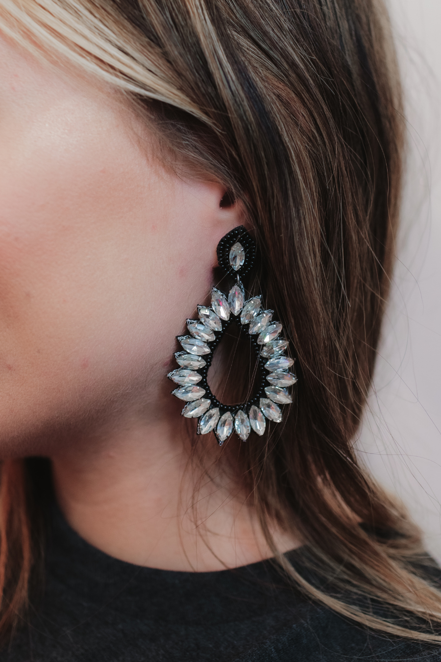 black rhinestone-embellished teardrop drop earrings with a subtle dangle movement, a coordinating stud top, soft felt backing, and secure comfort back