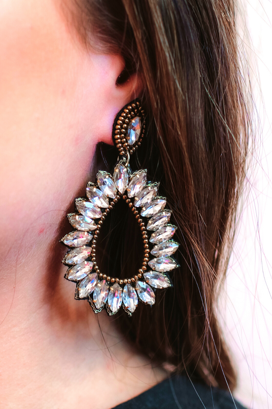 gold rhinestone-embellished teardrop drop earrings with a subtle dangle movement, a coordinating stud top, soft felt backing, and secure comfort back