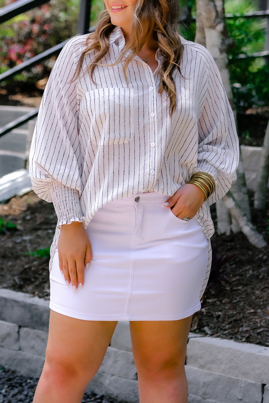 a classic white denim skirt with a little stretch, five-pocket style, and a zip fly with button closure