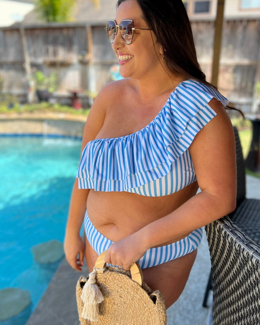 two-piece swimsuit with a ruffle bikini crop top and a full coverage high-waisted bottom on a blue and white striped pattern