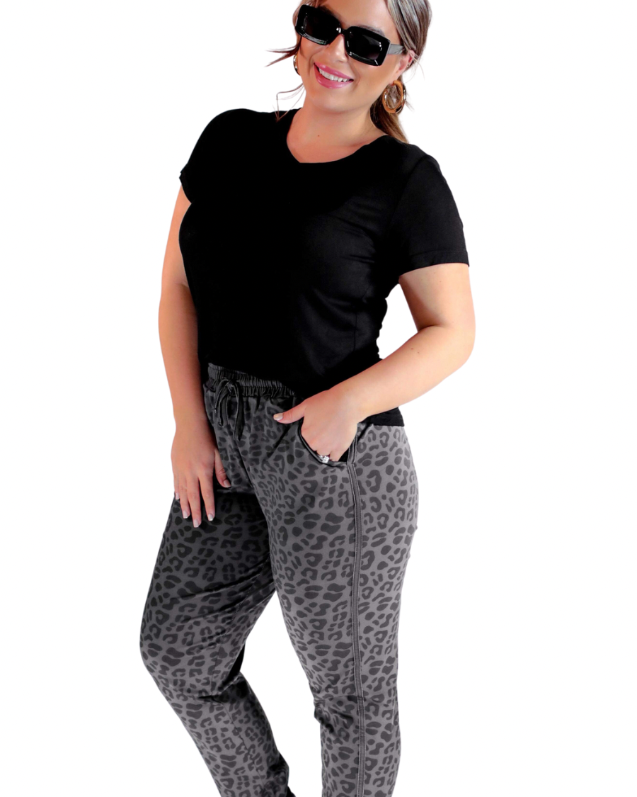 a mid-rise relaxed fit joggers with side pockets and a tie waist drawstring, designed on a black-on-black leopard pattern print and black base