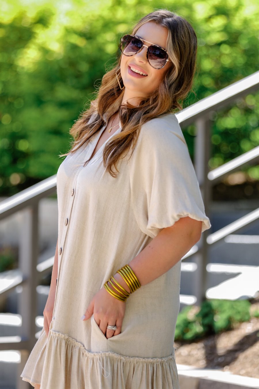 relaxed short-sleeve dress with a V-cut collar, full-button front closure, side pockets, and tiered ruffled hemline in oatmeal