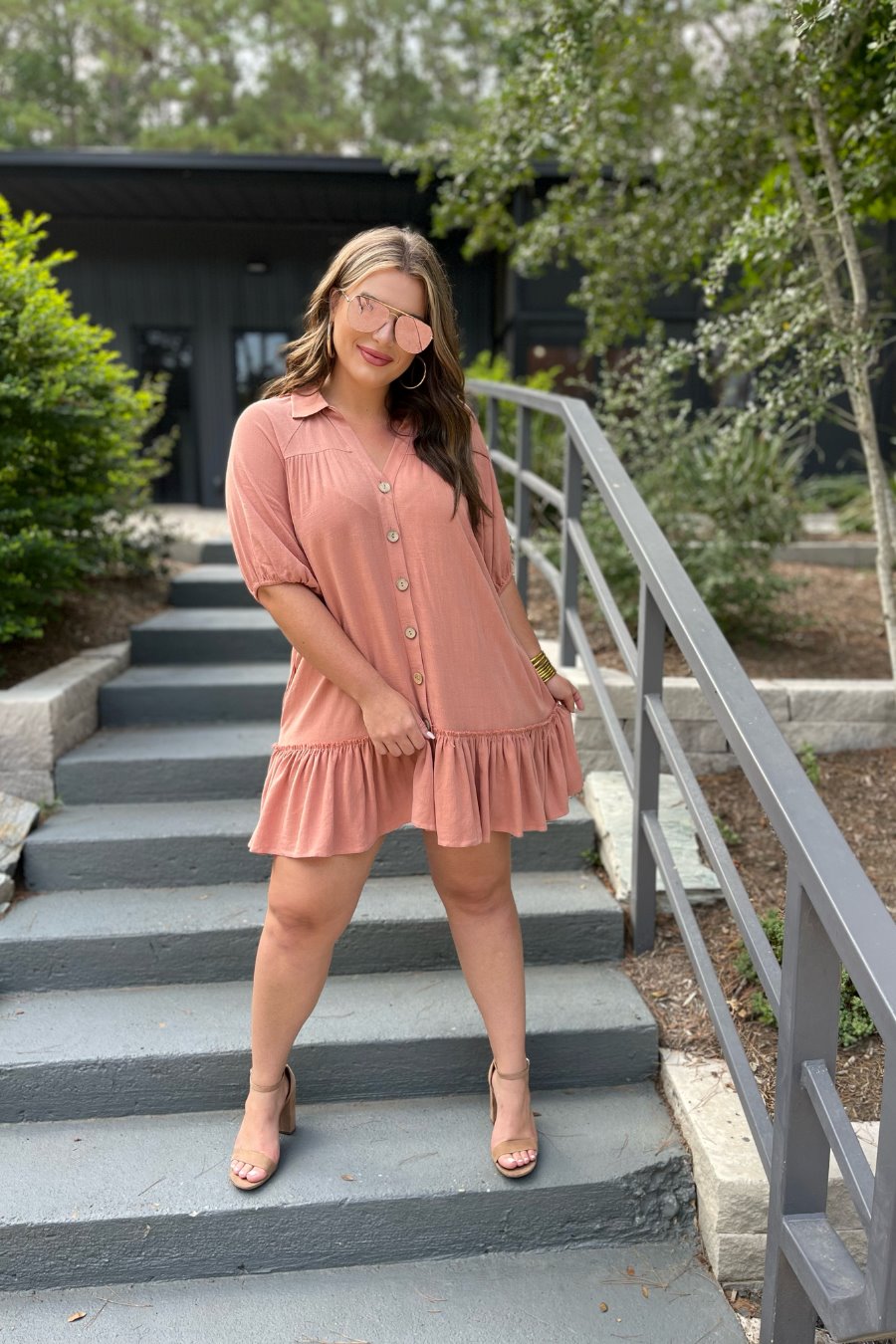 relaxed short-sleeve dress with a V-cut collar, full-button front closure, side pockets, and tiered ruffled hemline in apricot