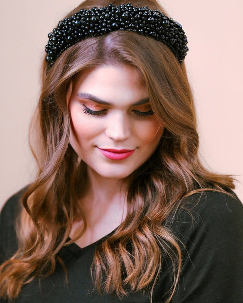 a soft, structured headband adorned with beautifully clustered pearls in varying sizes in black