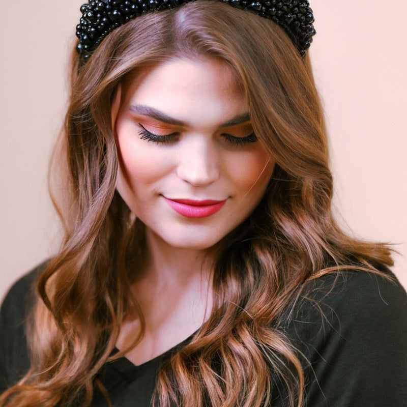 a soft, structured headband adorned with beautifully clustered pearls in varying sizes in black