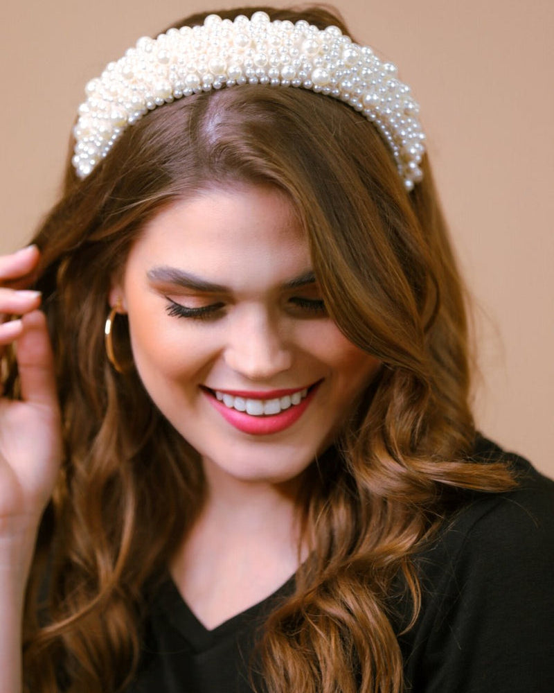 a soft, structured headband adorned with beautifully clustered pearls in varying sizes in ivory