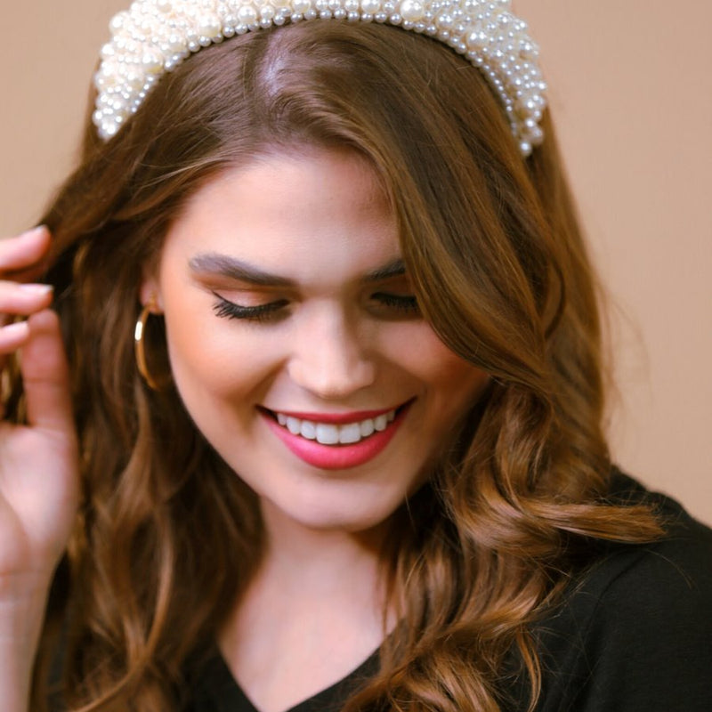 a soft, structured headband adorned with beautifully clustered pearls in varying sizes in ivory