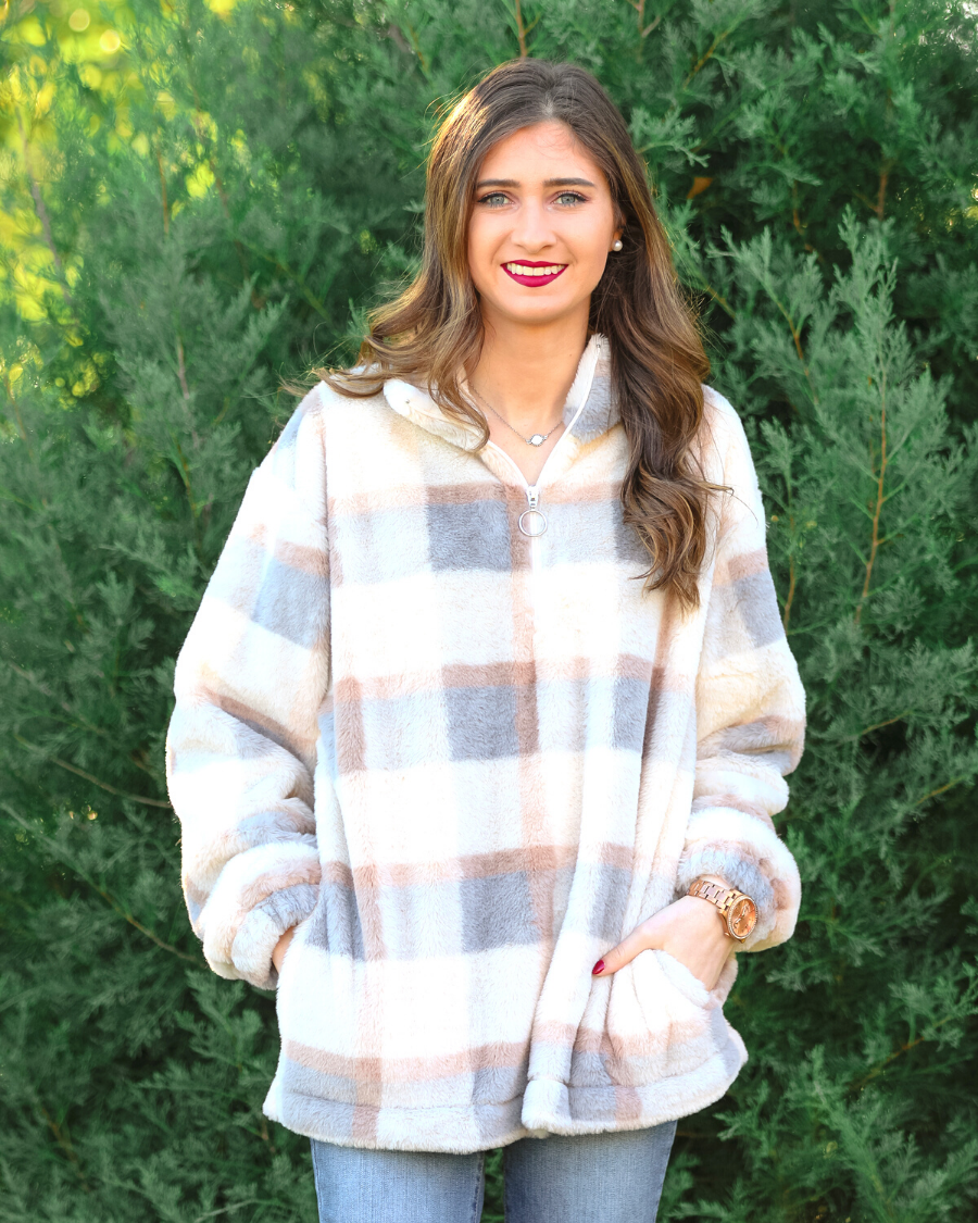 a taupe long-sleeve pullover with a neutral plaid pattern, a quarter zip, a foldable collar, and pockets made of a super soft material