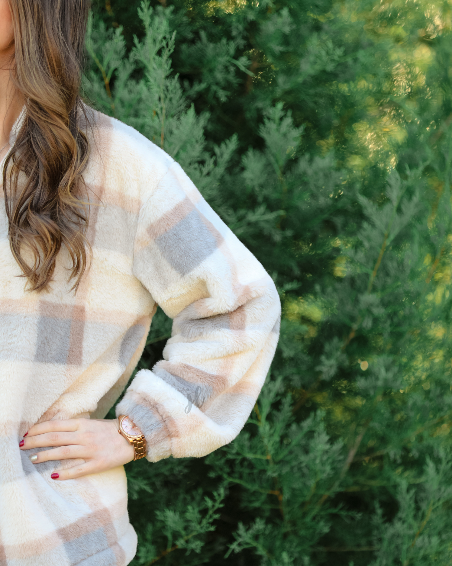 a taupe long-sleeve pullover with a neutral plaid pattern, a quarter zip, a foldable collar, and pockets made of a super soft material