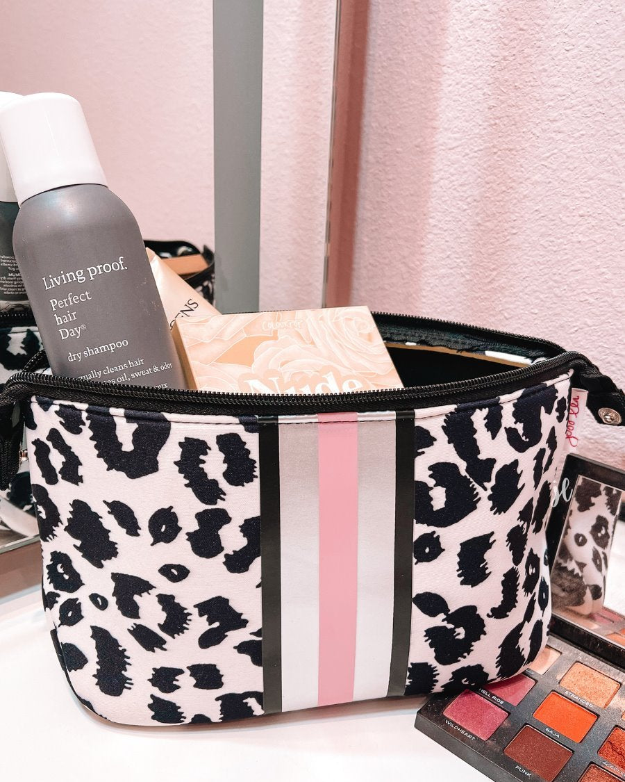 neoprene cosmetic bag in a black and pink leopard print with dual top zippers (black), expandable side snaps (silver), and racing stripes (black, gray, and pink)