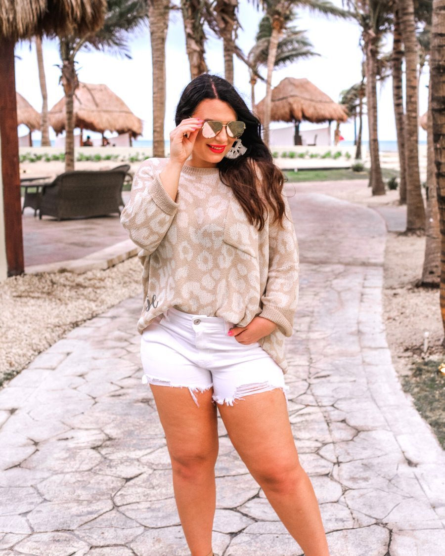 three-quarter cuffed sleeve unlined sweater crafted from loose knit material with an oversized fit, a rounded neckline, a chest pocket, and trim on the collar, hem, and pocket on a ivory leopard and tan base