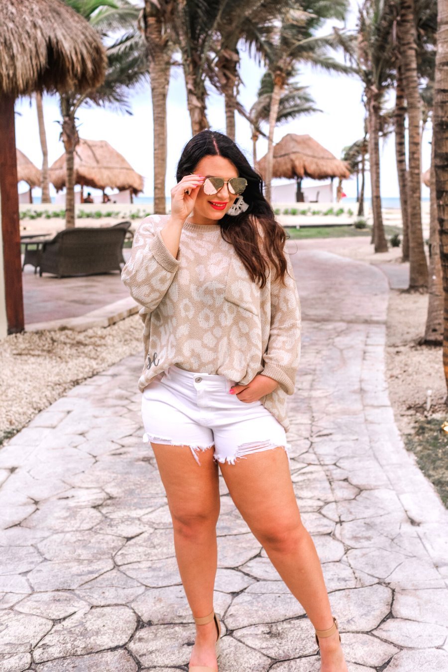 three-quarter cuffed sleeve unlined sweater crafted from loose knit material with an oversized fit, a rounded neckline, a chest pocket, and trim on the collar, hem, and pocket on a ivory leopard and tan base