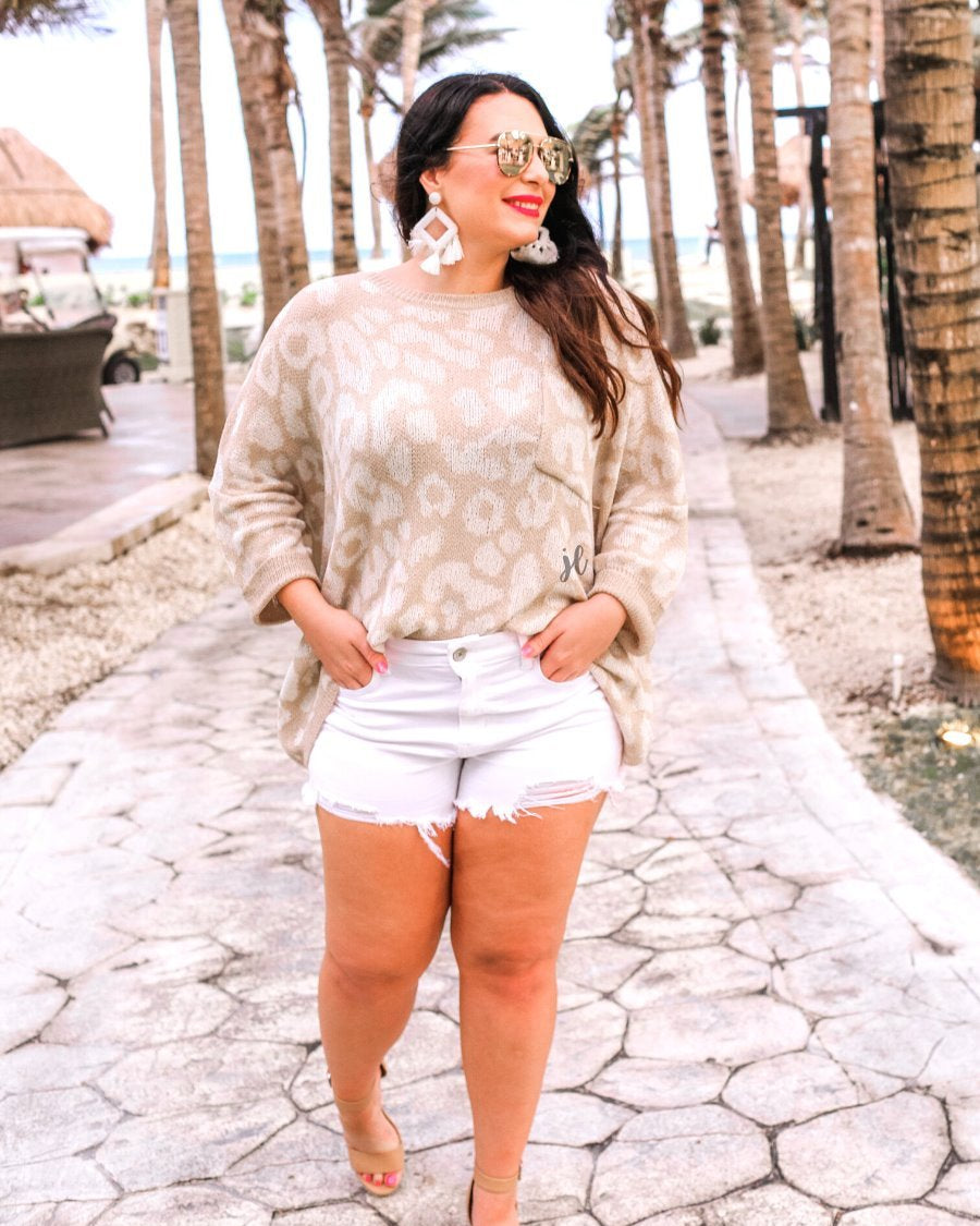 three-quarter cuffed sleeve unlined sweater crafted from loose knit material with an oversized fit, a rounded neckline, a chest pocket, and trim on the collar, hem, and pocket on a ivory leopard and tan base