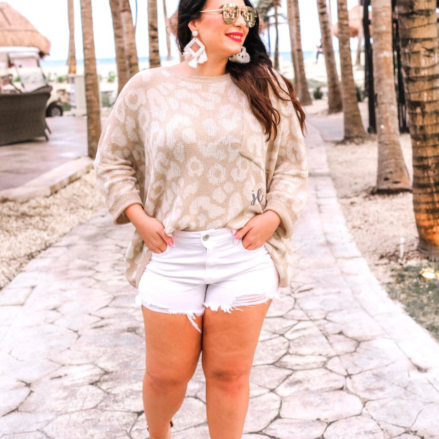 three-quarter cuffed sleeve unlined sweater crafted from loose knit material with an oversized fit, a rounded neckline, a chest pocket, and trim on the collar, hem, and pocket on a ivory leopard and tan base