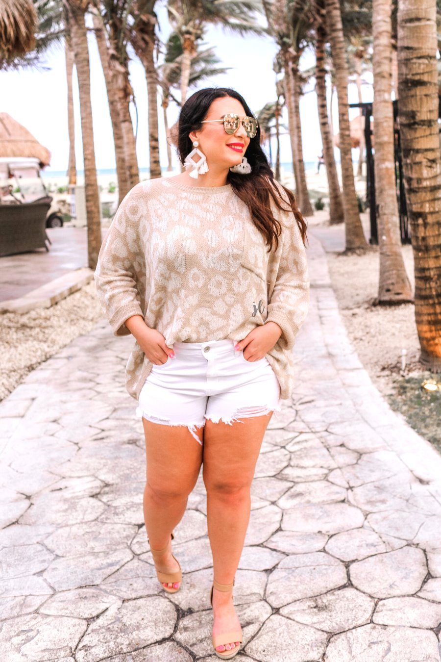 three-quarter cuffed sleeve unlined sweater crafted from loose knit material with an oversized fit, a rounded neckline, a chest pocket, and trim on the collar, hem, and pocket on a ivory leopard and tan base