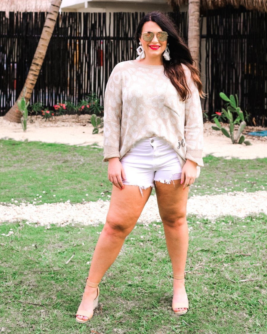 three-quarter cuffed sleeve unlined sweater crafted from loose knit material with an oversized fit, a rounded neckline, a chest pocket, and trim on the collar, hem, and pocket on a ivory leopard and tan base