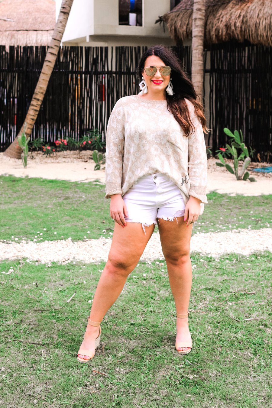 three-quarter cuffed sleeve unlined sweater crafted from loose knit material with an oversized fit, a rounded neckline, a chest pocket, and trim on the collar, hem, and pocket on a ivory leopard and tan base