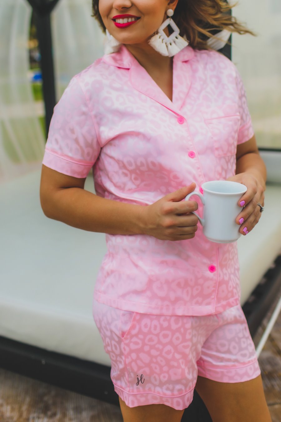 a pink satin two-piece lounge set sold together with a tonal leopard pattern, collared button-down top, short sleeves, a chest pocket, piped trim, and matching shorts with an elastic drawstring waist and accent side pocketsRelax Lounge Set PINK
