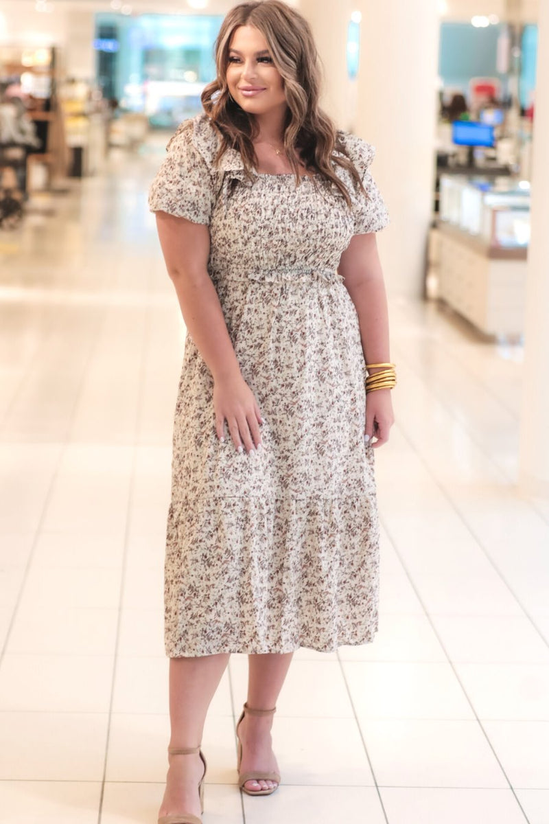 a lightweight ditsy floral midi dress with a smocked bodice, square neckline, ruffled trim and cap sleeves (wearable on or off the shoulder), and a relaxed silhouette that falls into a mid-calf hemline