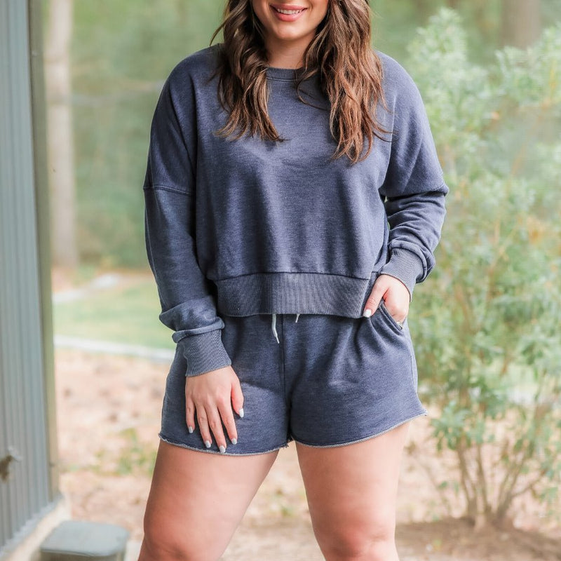 vintage wash navy long sleeve top and short set with side pockets, an elastic drawstring waistband, and a relaxed fit on a super soft material