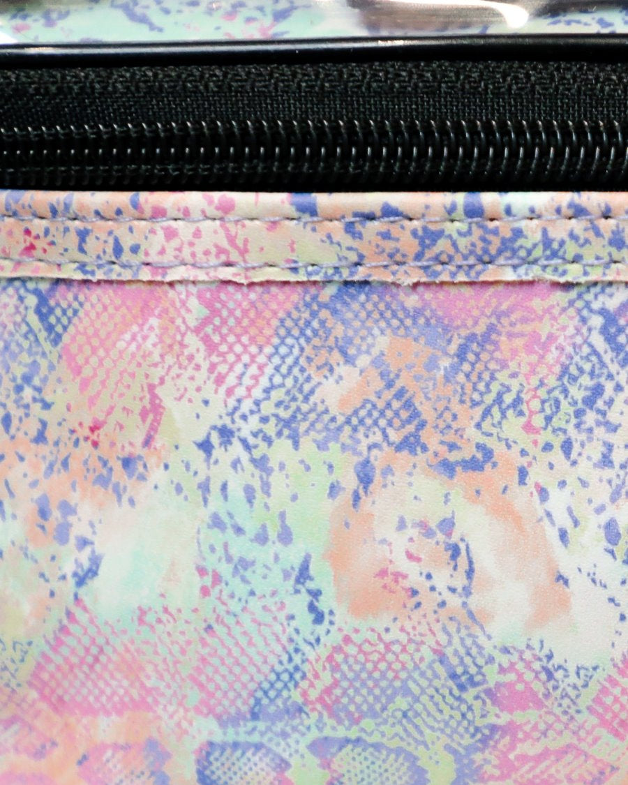 two-tier design with a clear compartment, four brush slots with an elastic band on the inside lid of the main compartment, and a grab-and-go handle with dual gold zippers in a soft pastel snakeskin print