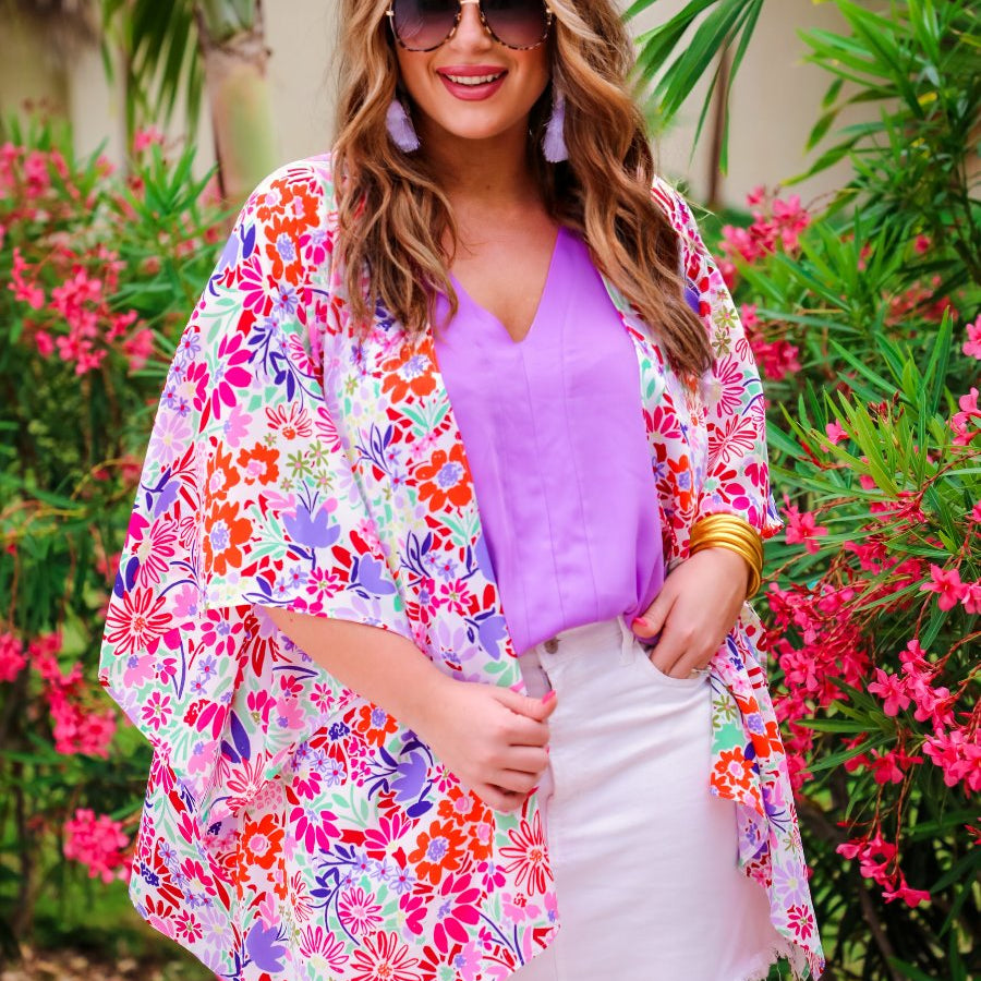 a lightweight multicolor floral kimono with loose short sleeves, an open front, and a relaxed, flowy silhouette with a straight hemline