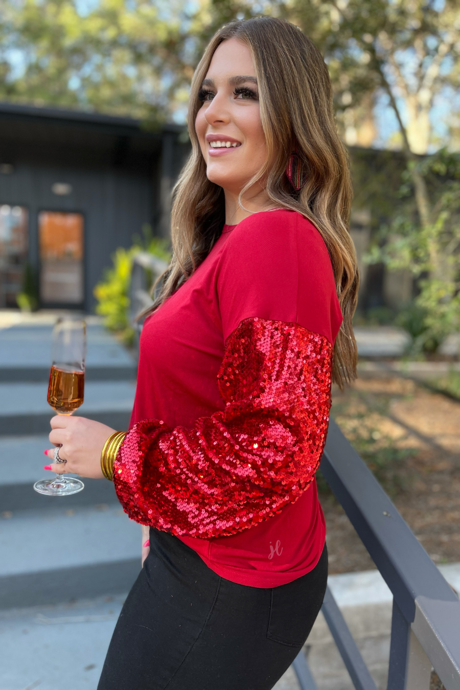 a red long-sleeve crewneck top with shimmering sequin balloon sleeves, a relaxed drop-shoulder silhouette, and softly gathered cuffs