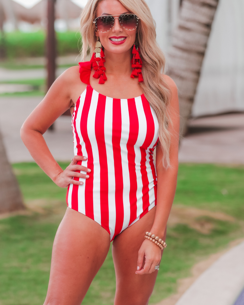red and white vertical stripe one-piece swimsuit with ruffle sleeves, crisscross straps, removable padding, and an open front