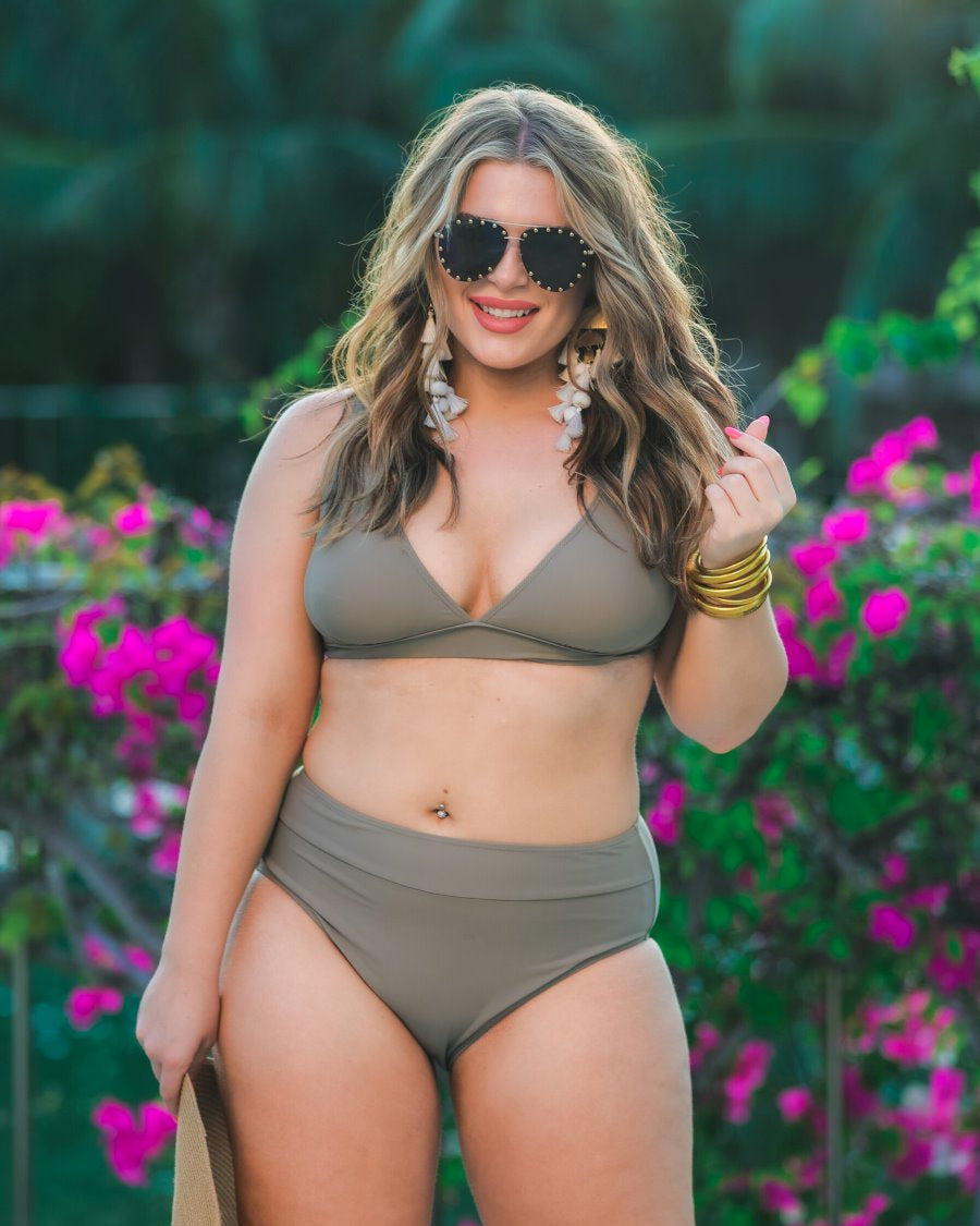 two-piece swimsuit made of stretchy material with a triangle bikini top, chunky straps, and removable padding paired with high-waisted bottoms on a solid mushroom color fabric