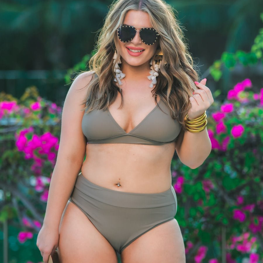 two-piece swimsuit made of stretchy material with a triangle bikini top, chunky straps, and removable padding paired with high-waisted bottoms on a solid mushroom color fabric