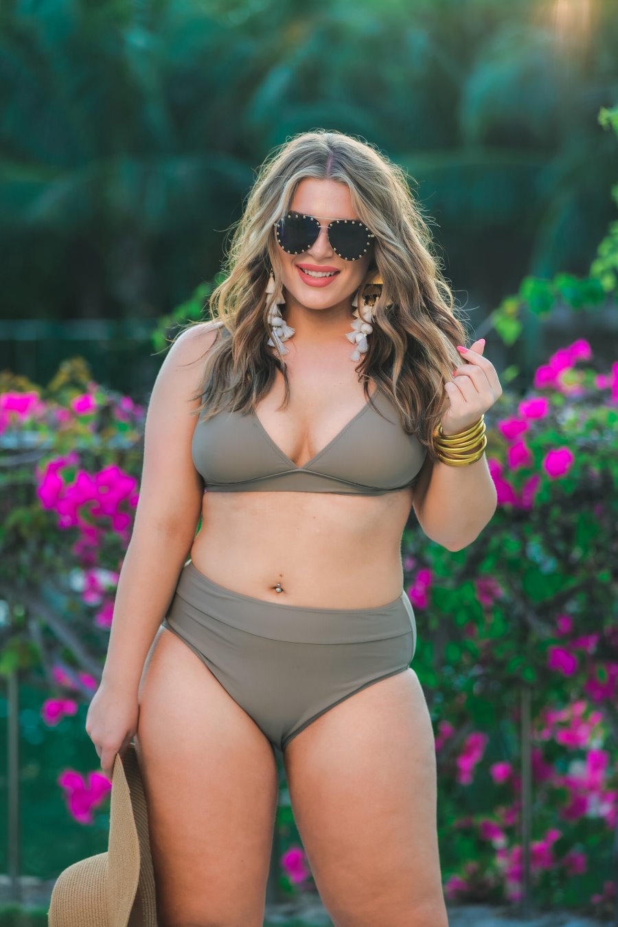 two-piece swimsuit made of stretchy material with a triangle bikini top, chunky straps, and removable padding paired with high-waisted bottoms on a solid mushroom color fabric