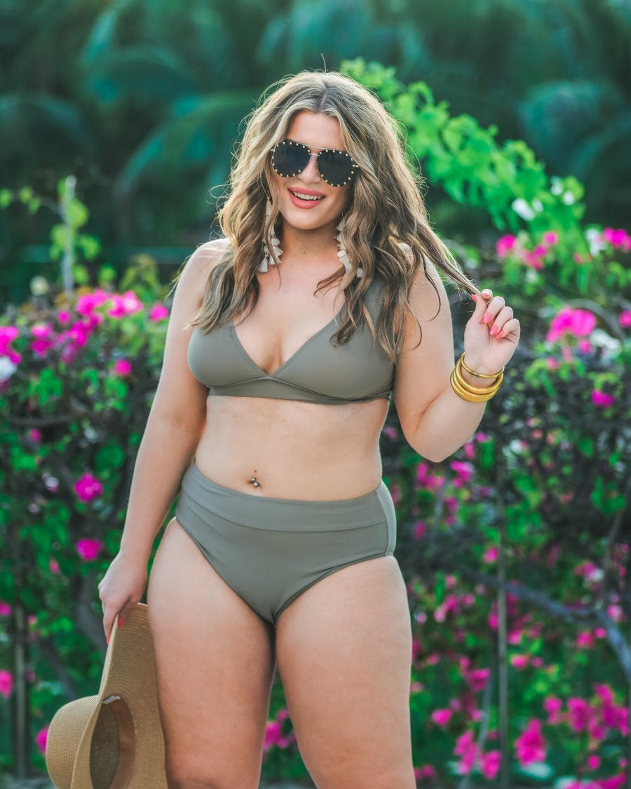 two-piece swimsuit made of stretchy material with a triangle bikini top, chunky straps, and removable padding paired with high-waisted bottoms on a solid mushroom color fabric