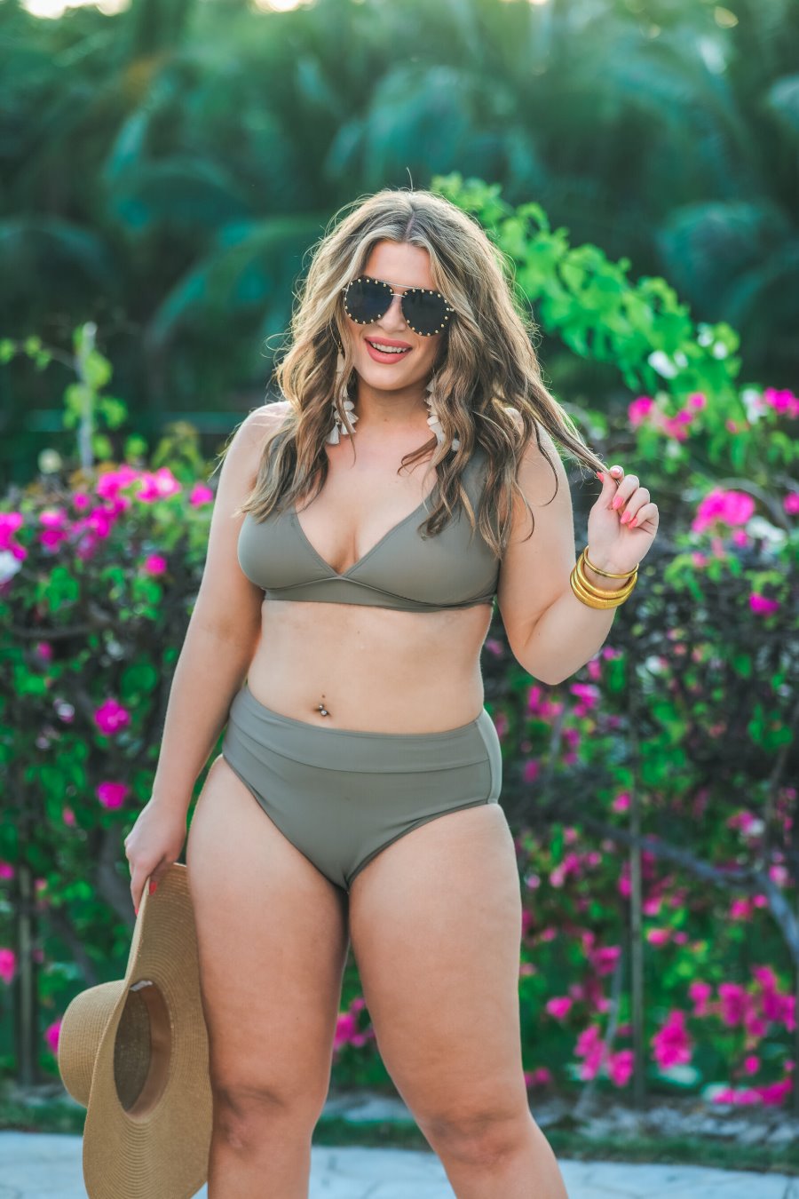 two-piece swimsuit made of stretchy material with a triangle bikini top, chunky straps, and removable padding paired with high-waisted bottoms on a solid mushroom color fabric