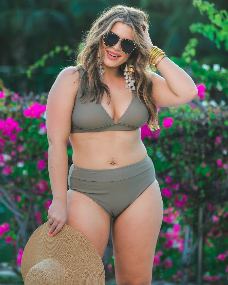 two-piece swimsuit made of stretchy material with a triangle bikini top, chunky straps, and removable padding paired with high-waisted bottoms on a solid mushroom color fabric