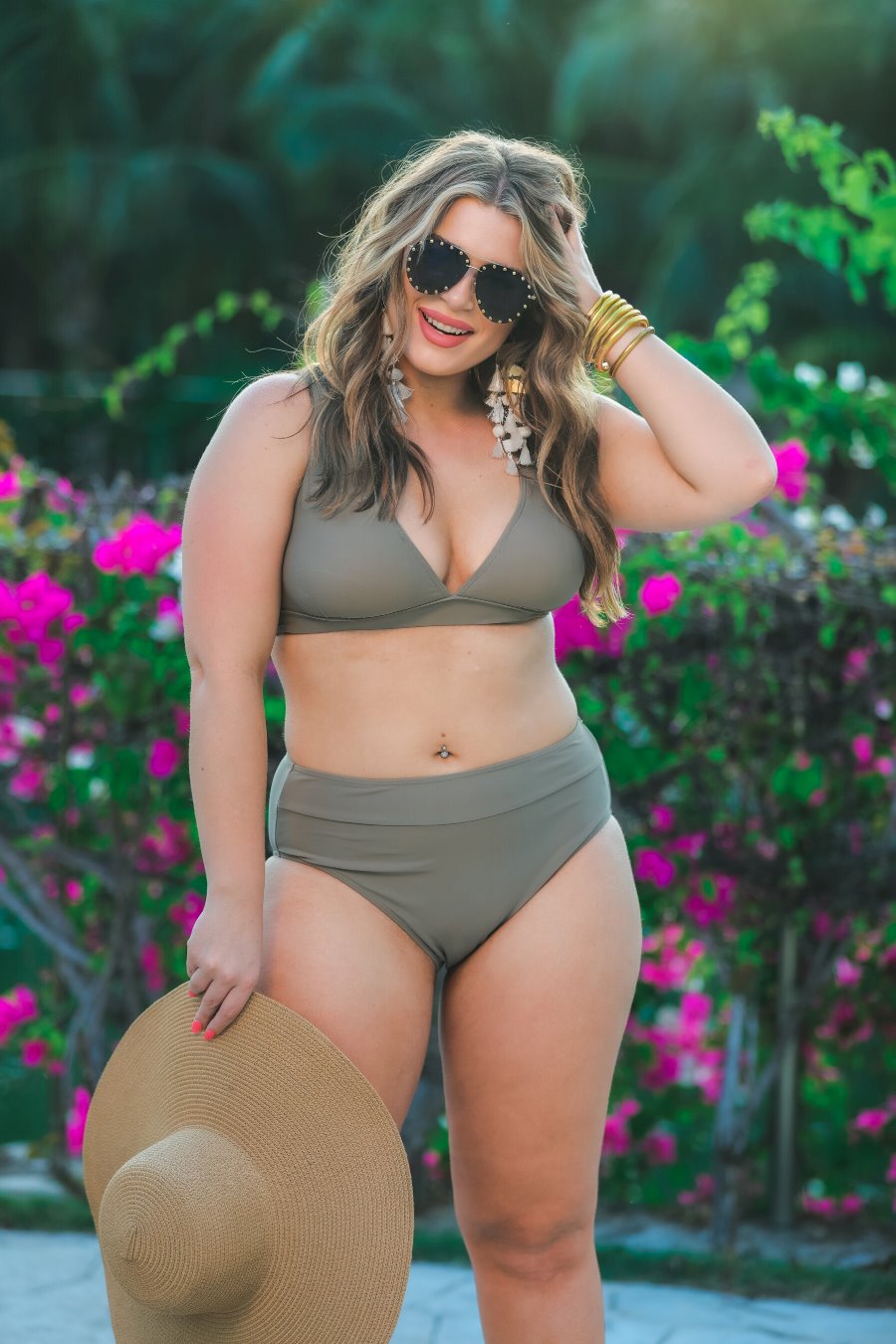 two-piece swimsuit made of stretchy material with a triangle bikini top, chunky straps, and removable padding paired with high-waisted bottoms on a solid mushroom color fabric