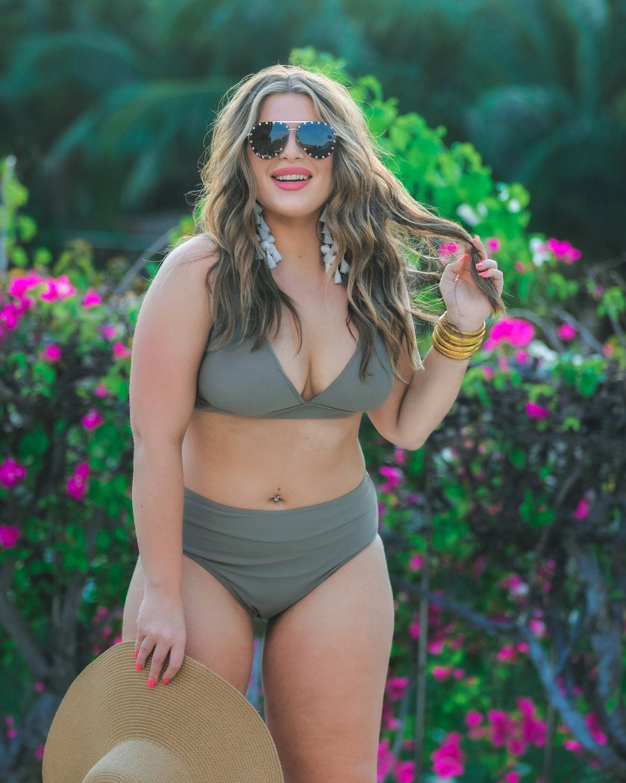 two-piece swimsuit made of stretchy material with a triangle bikini top, chunky straps, and removable padding paired with high-waisted bottoms on a solid mushroom color fabric