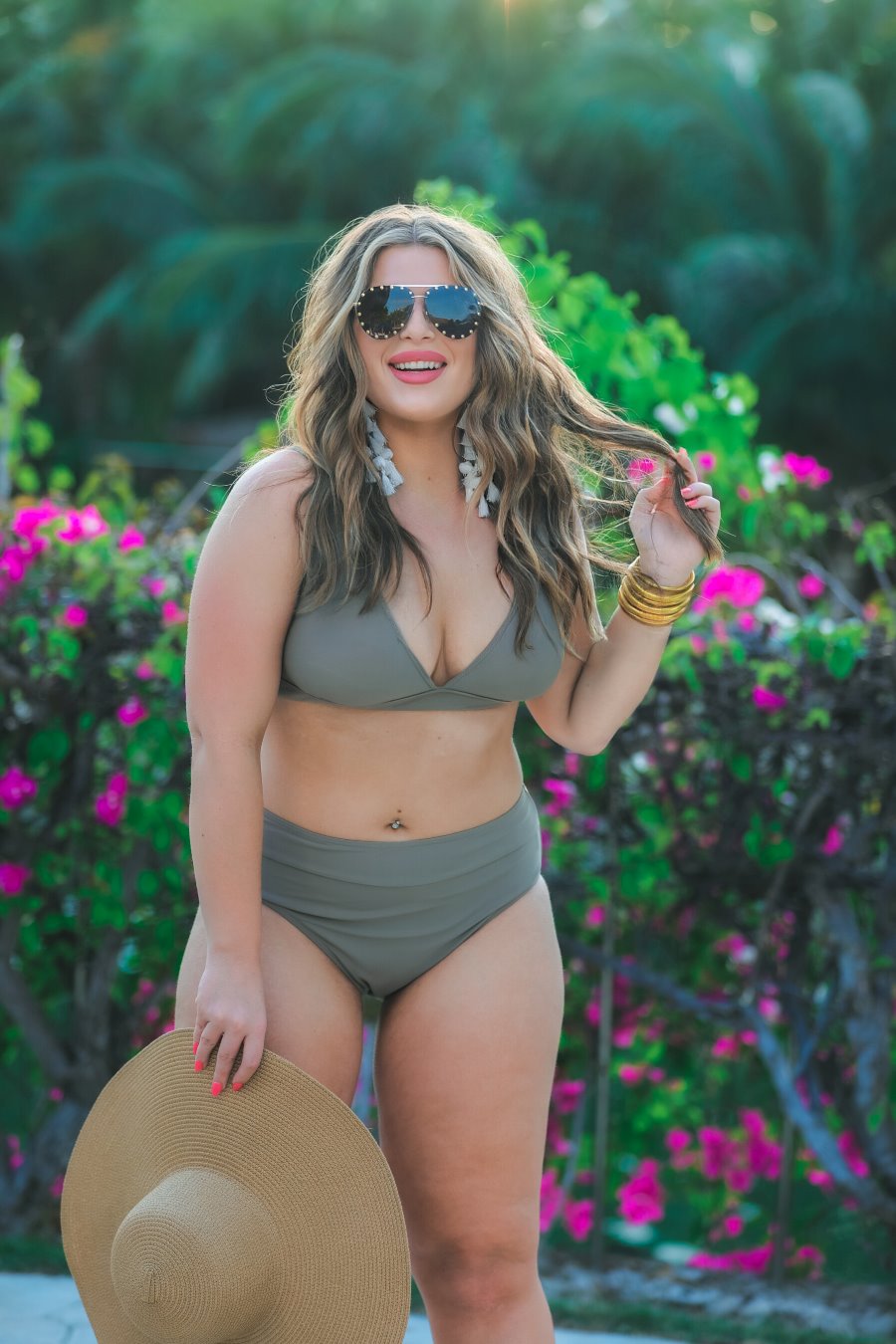 two-piece swimsuit made of stretchy material with a triangle bikini top, chunky straps, and removable padding paired with high-waisted bottoms on a solid mushroom color fabric