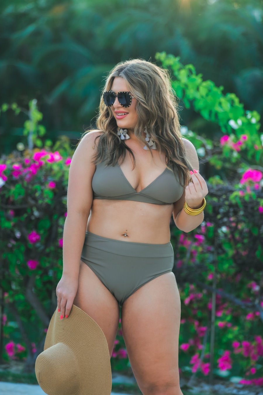 two-piece swimsuit made of stretchy material with a triangle bikini top, chunky straps, and removable padding paired with high-waisted bottoms on a solid mushroom color fabric