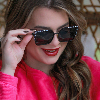 black square frames with pearl trim along the top and sides of the black frame, nose pads, UV protection, and brand name detail (on both the temple and the complimentary black pouch)