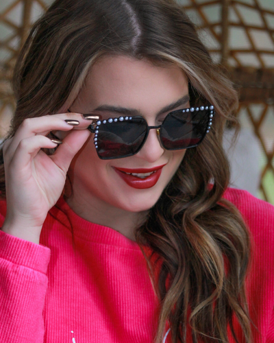 black square frames with pearl trim along the top and sides of the black frame, nose pads, UV protection, and brand name detail (on both the temple and the complimentary black pouch)