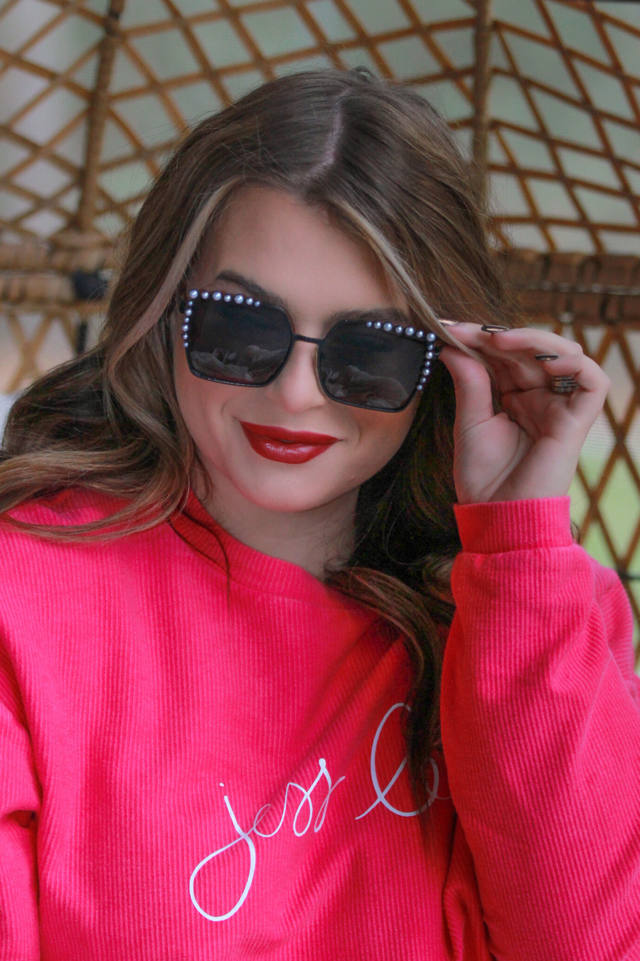 black square frames with pearl trim along the top and sides of the black frame, nose pads, UV protection, and brand name detail (on both the temple and the complimentary black pouch)