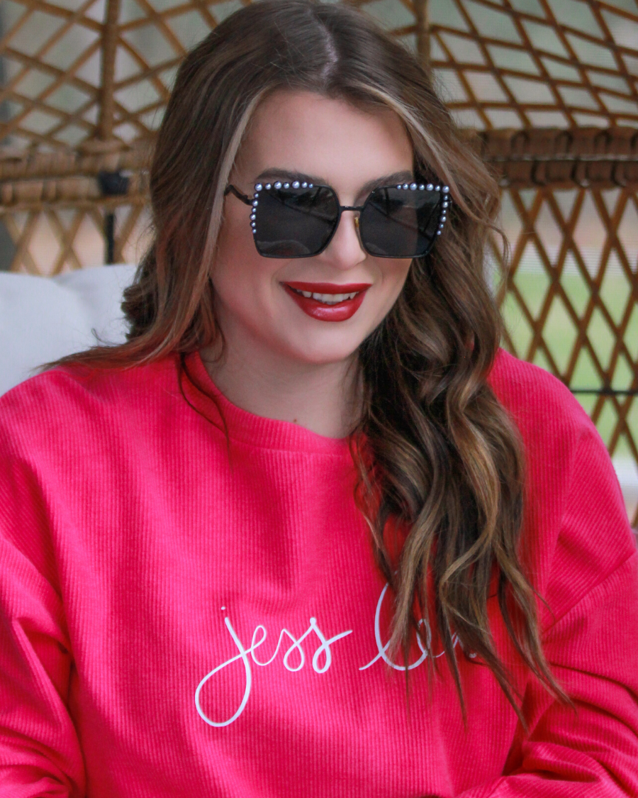 black square frames with pearl trim along the top and sides of the black frame, nose pads, UV protection, and brand name detail (on both the temple and the complimentary black pouch)